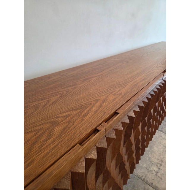 A striking Brutalist sideboard, model “Aurora,” distinguished by its bold architectural presence and sculptural front....