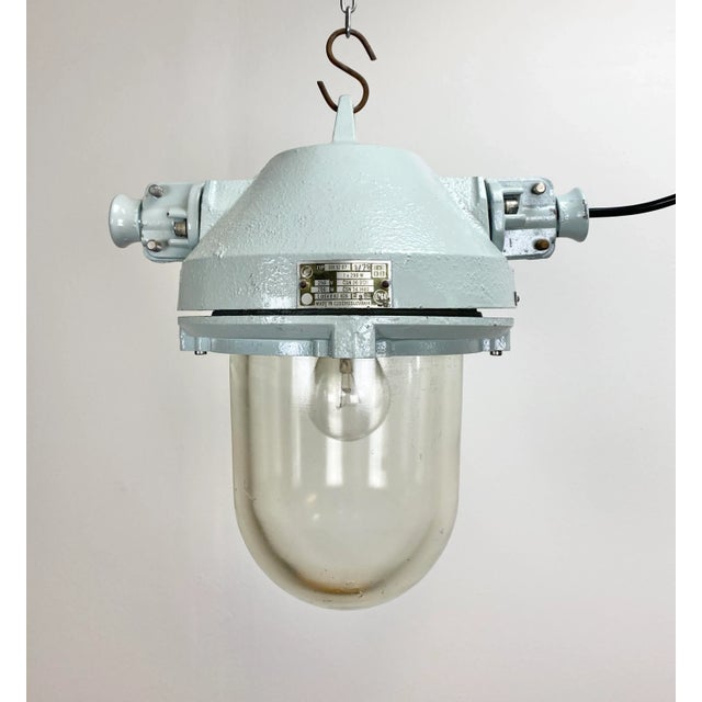 This industrial lamp was made by Elektrosvit in the 1970s. The lam has a grey cast aluminium body and massive protective...