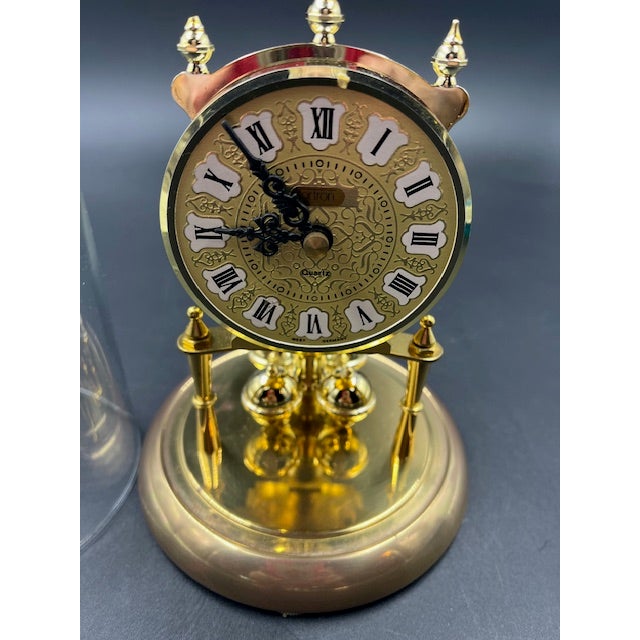 Late 19th century small German clock with glass dome. The ball weights circle (turn) back and forth. Requires one AA...