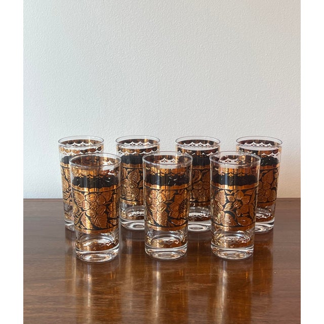 Elegant set of seven mid-century highball glasses designed by Georges Briard, featuring a bold black and 22-karat gold...