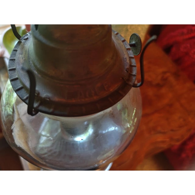 Pair of Antique oil lamps. The glass hurricane and the wick are new. The lamps are functional. The makers mark is stamped...