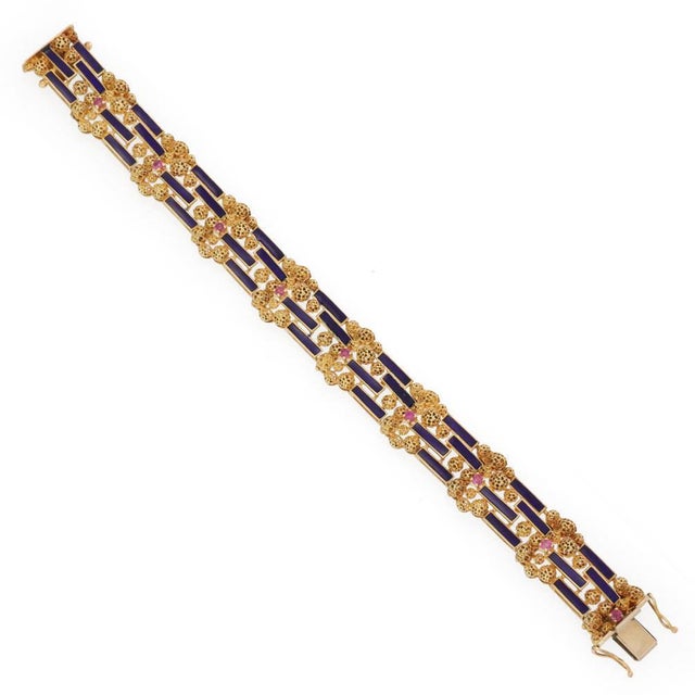 This is a lovely ruby and enamel bracelet, crafted from 18k yellow gold featuring a 15mm wide flex link set with a mixture...