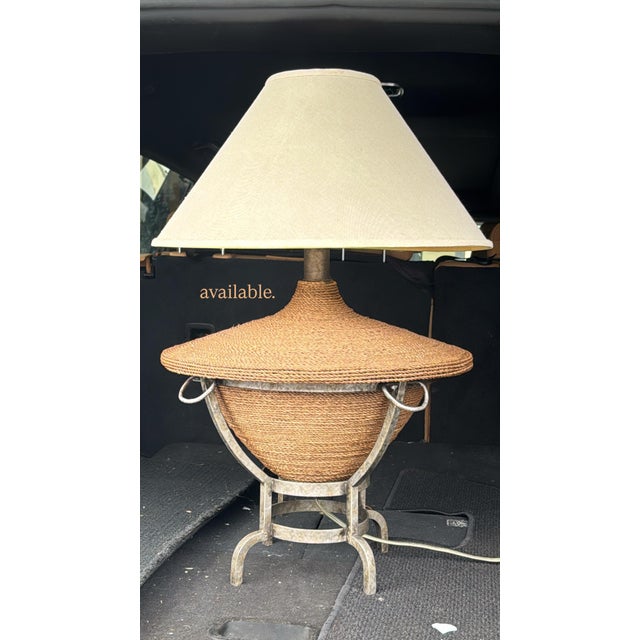 Beautiful vintage 1990s table lamp featuring a sculptural, woven raffia and dark wicker body with a unique urn-inspired...