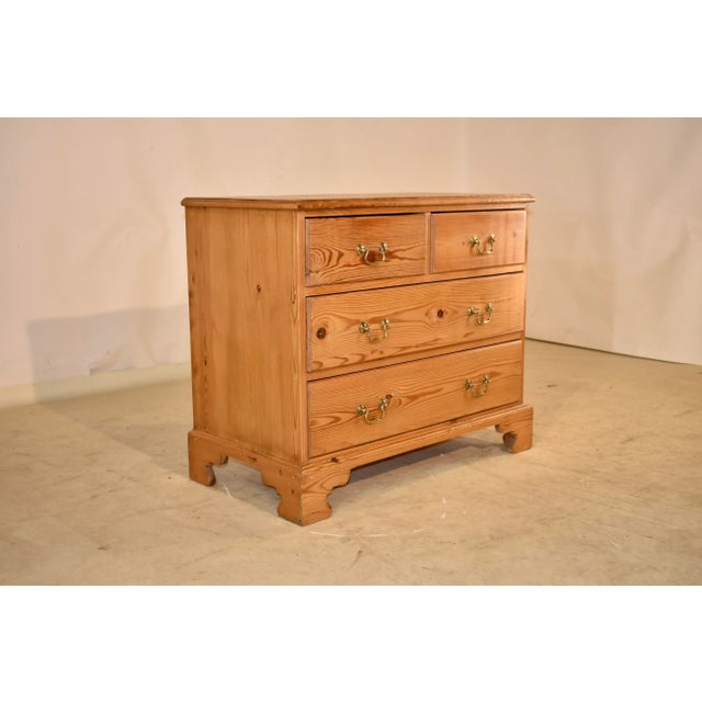 Mid 20th century pine chest of drawers from England with a beveled edge around the top, following down to simple sides and...