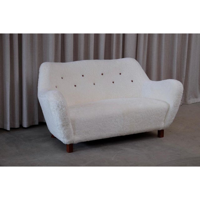 Reupholstered in white sheepskin from Skandilock. Produced by Sten Wicéns Möbelfabrik, Sweden, 1950s. Excellent condition....