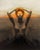 Ascend by Josh Sorrell | Oil on panel Woman with hands on head against a sunset background. For Sale