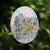 This mixed media piece features a vibrant kumquat tree set against a softly rendered architectural backdrop, blending...
