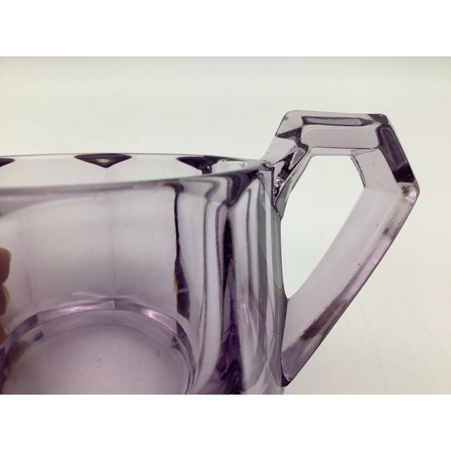 A lovely antique amethyst glass serving dish used for sugar. The sugar dish has two cute handles. The measurements are 6...