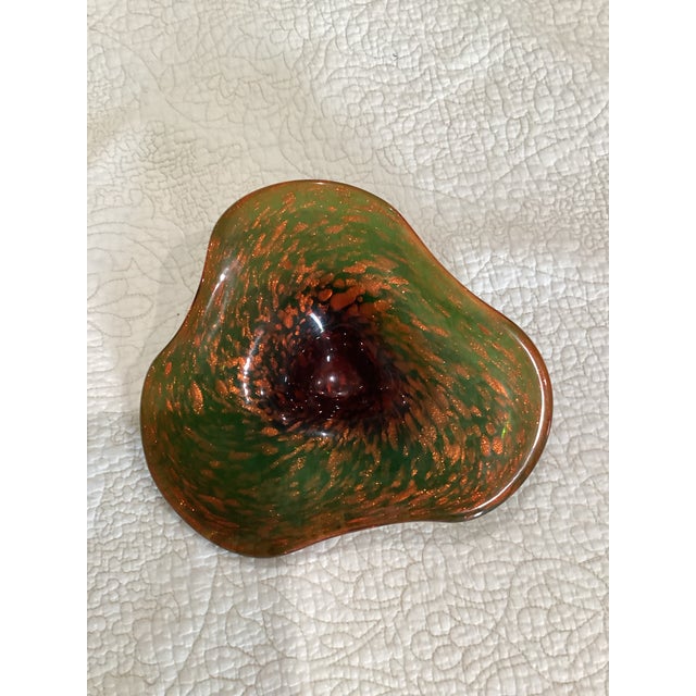 Vintage Murano biomorphic art glass bowl by Fratelli Toso in the. It is amber on top green on bottom with copper...