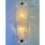 Scenographic wall sconce made in clear graniglia of Murano glass. Made with a traditional Murano glass slab processing...