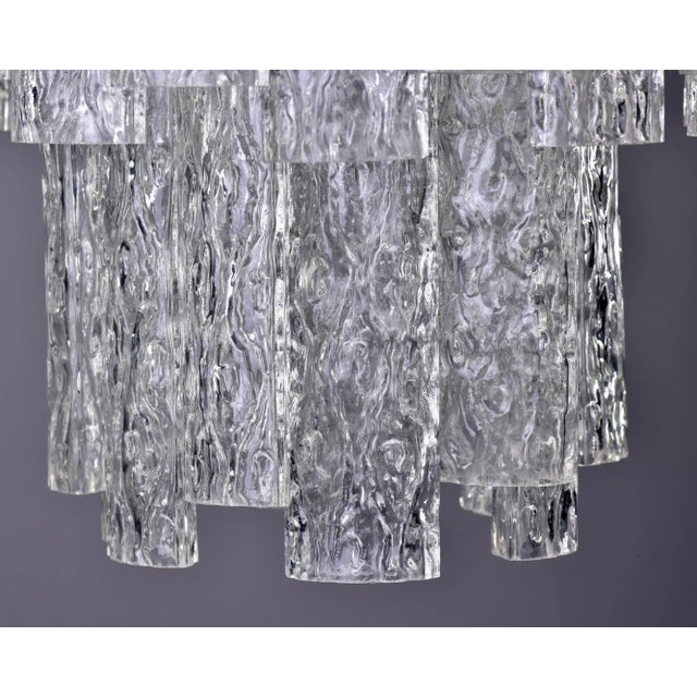 Circa 1960s chandelier with three tiers of clear, textured tronchi glass tubes. Six candelabra sized sockets. New wiring...