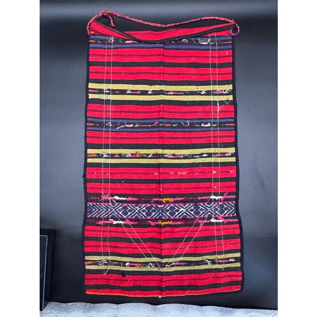 Beautiful Bulgarian Prestilka apron, a traditional folk costume garment featuring hand-woven wool with colorful stripes,...