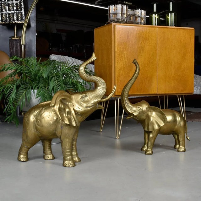 Exceptional pair of vintage large scale brass elephant sculptures. One is larger, one is slightly smaller but they both...