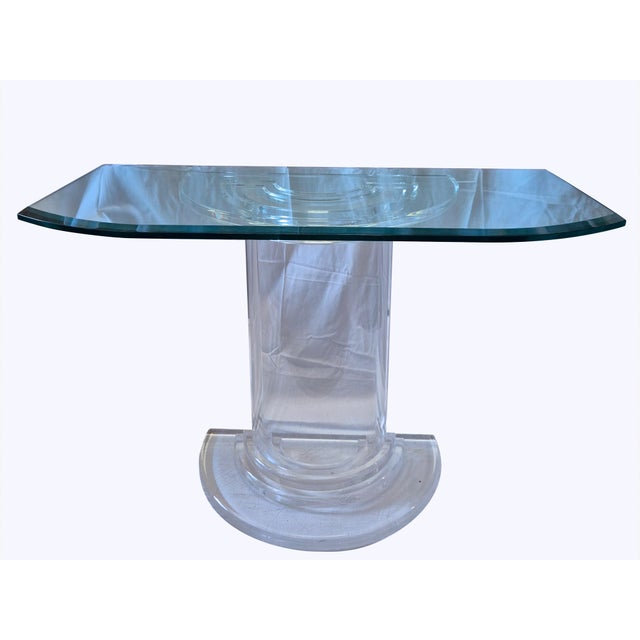 An elegant mid-century Italian-design console table, featuring a refined glass top with a beveled edge and rounded...