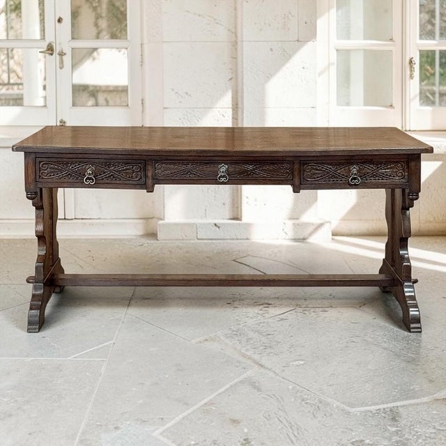 Inspired by the enduring forms of medieval furniture, this antique oak writing desk reflects the Neo-Gothic movement that...