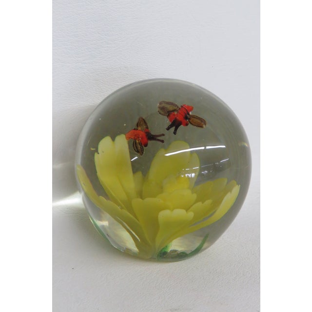 This stunning Floral Paperweight is made of hand blown art glass. This beautifully unique paperweight has a rounded...