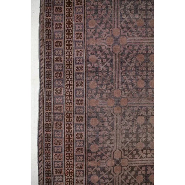 Stunning antique East Turkestan Khotan rug, with a pomegranate trellis overall within a series of reciprocal geometric...
