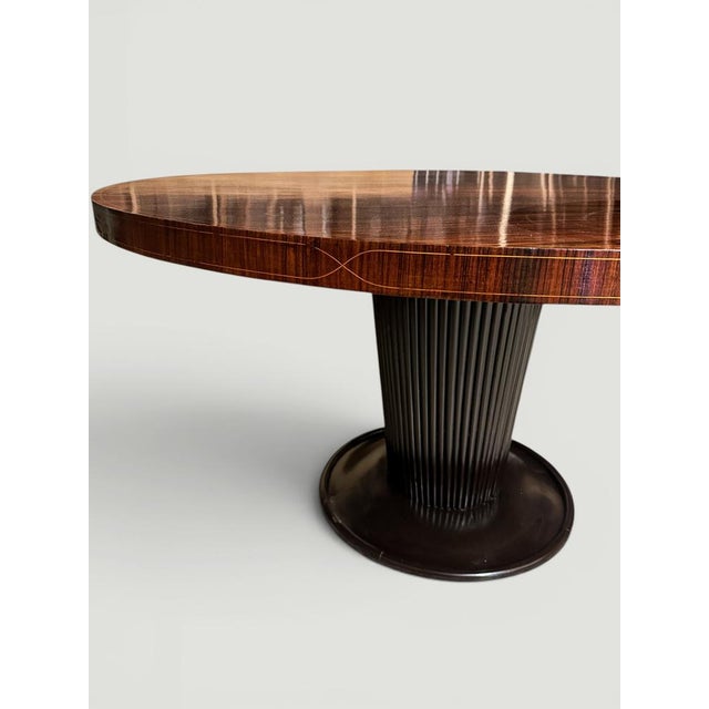 This elegant Italian round dining table, attributed to Osvaldo Borsani, and produced in the late twentieth century,...