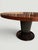 This elegant Italian round dining table, attributed to Osvaldo Borsani, and produced in the late twentieth century,...