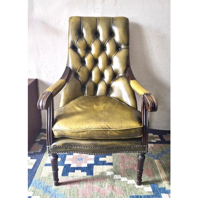 Vintage Chesterfield lounge chair in olive green tufted leather dating from about 1970. Well upholstered, very comfortable.