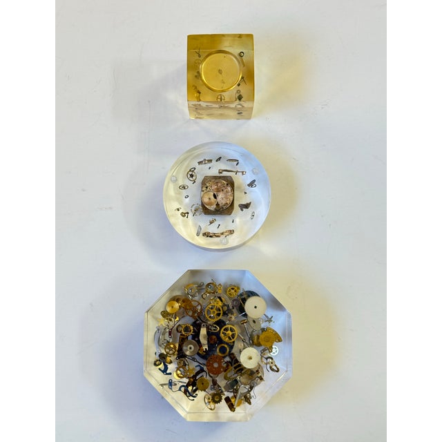 A wonderful vintage set of three "exploding clock" paperweight sculptures. Dating back to the 1960s or 1970s, these eye-...