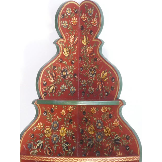 Vintage Folk Art wall cabinet with hand painted flowers. The beautiful corner cabinet is painted in red and green with...