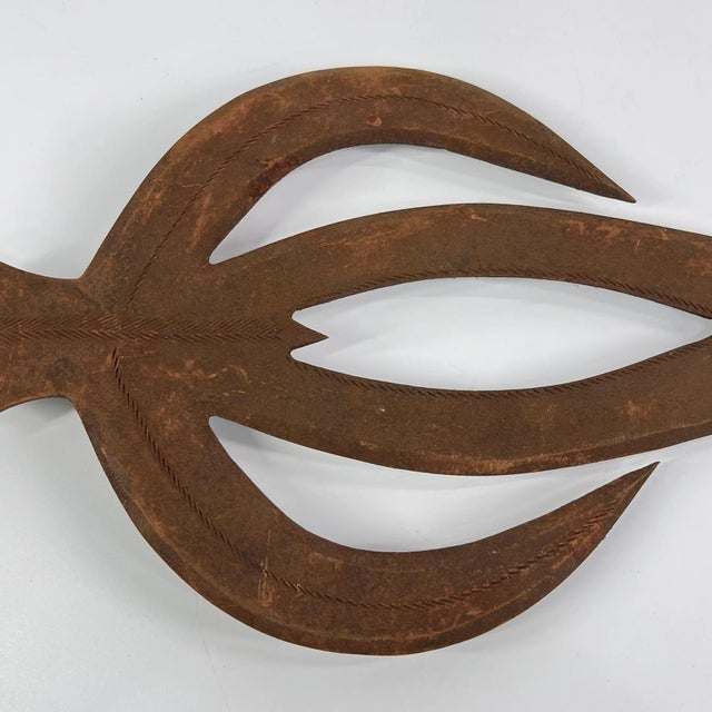 The Ngombe Executionerâs Prestige Knife Currency from the Congo is a powerful and visually striking object that embodies...
