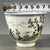 A charming Chinese porcelain tea cup. The white ground is hand-painted in vibrant Famille Rose enamels with a playful...