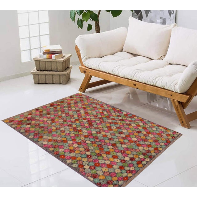This stunning hand-knotted Afghan Balouchi rug is a captivating addition to any decor. Crafted by skilled artisans, it...