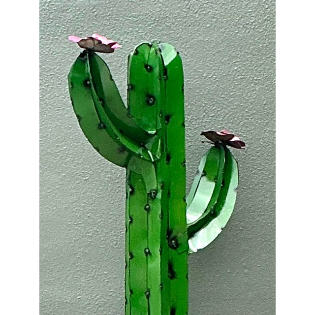This hand-crafted Saguaro cactus sculpture serves as a vibrant piece of Southwestern folk art, perfectly blending rustic...