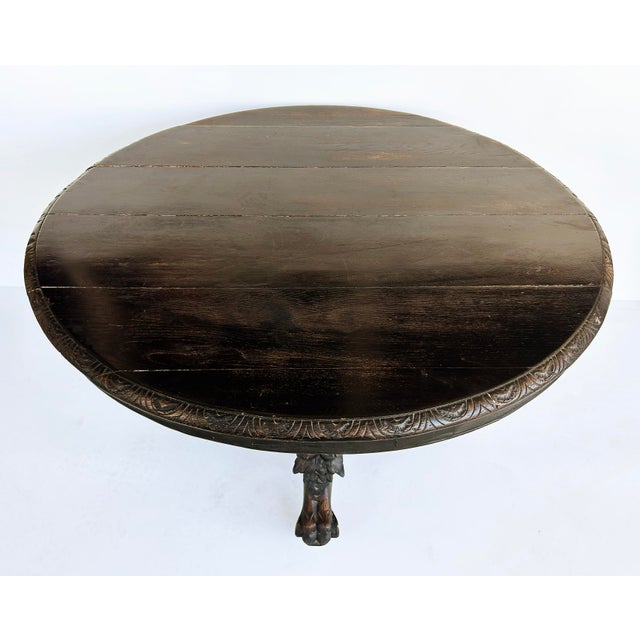 Antique Heavily Carved Griffins Wood Center, Game Table Offered for sale is an antique European heavily carved pedestal...