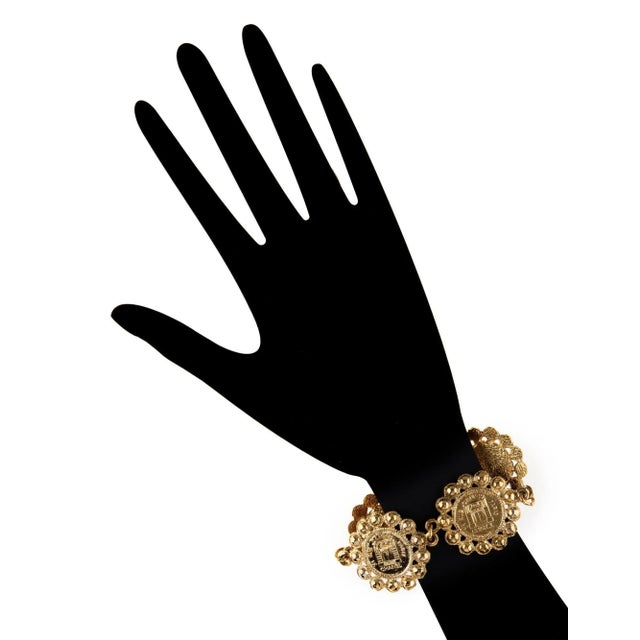 Vintage Chanel large medallion coin bracelet (circa 1980s) crafted in yellow gold tone. The bracelet features large 1 1/4...