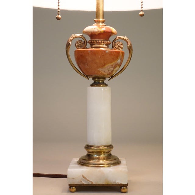 A sophisticated and elegant White & Salmon Onyx Marble Bronze/Brass Art Deco Neo Classic Urn/Column table lamp designed...