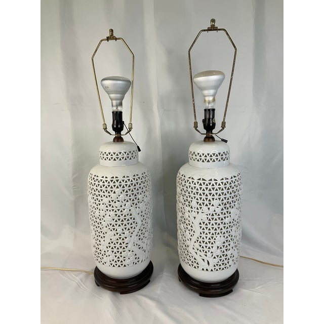 Elegant vintage Japanese Blanc de Chine porcelain table lamps featuring an intricate reticulated lattice body with applied...