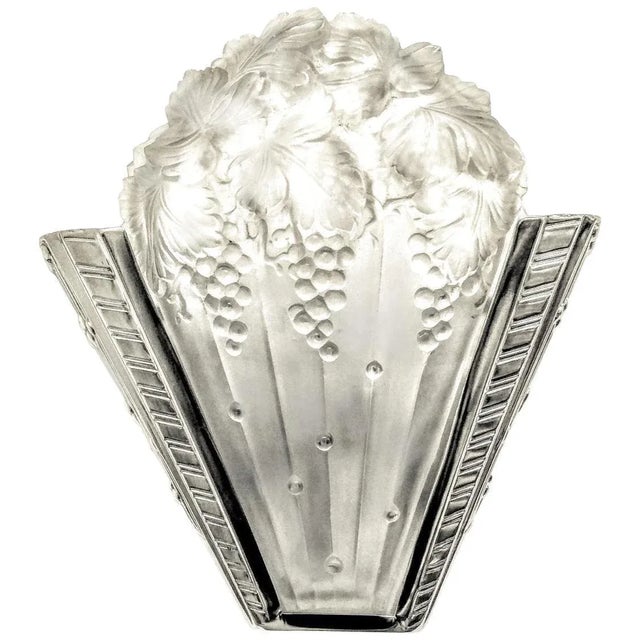 A stunning pair of French Art Deco wall sconces by the French artist "Marius Ernest Sabino" in clear and frosted molded...