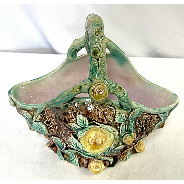 Pretty vintage Italian majolica vase. The ceramic piece has a basket shape with faux bois tree limb, birds nest and leaf...