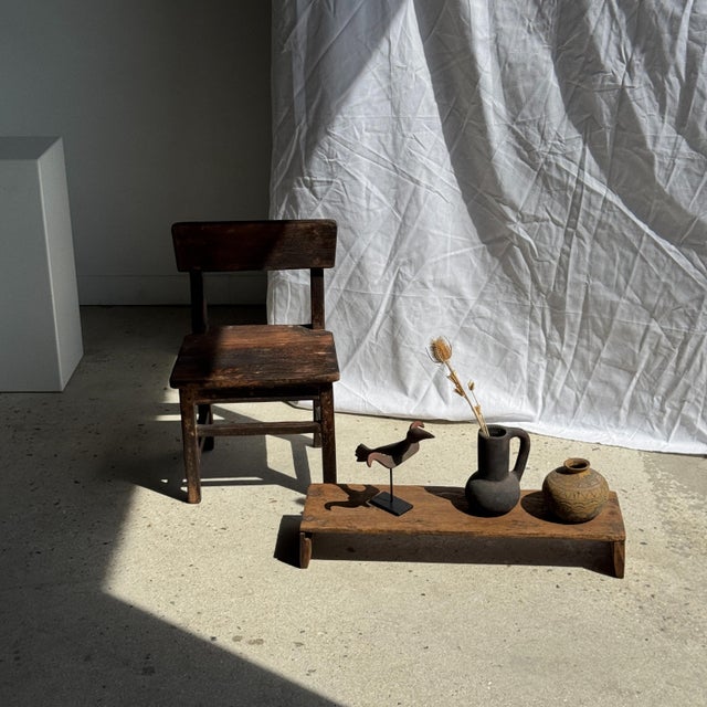 Small antique Indonesian teak bench. Made of solid antique teak, the natural imperfections of the wood (irregularities,...