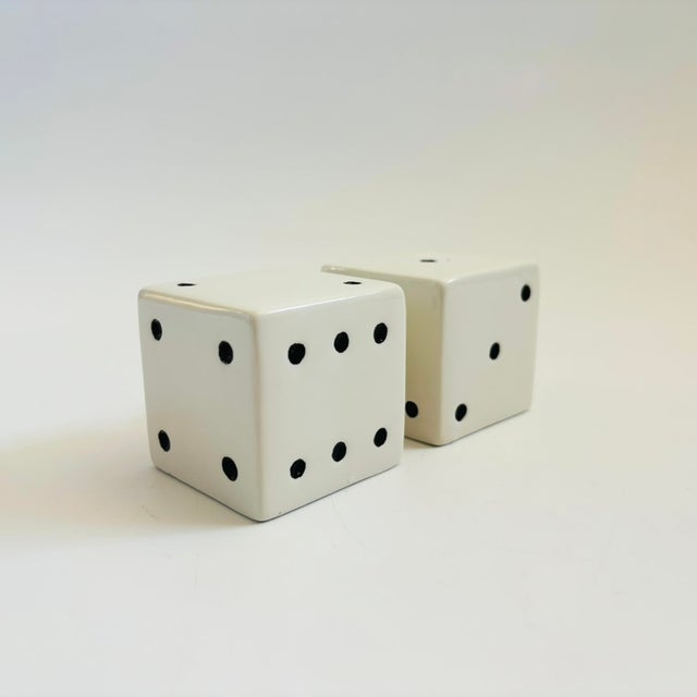 A pair of vintage ceramic salt and pepper shakers in the shape of dice, each with a removable plastic stopper. Each shaker...