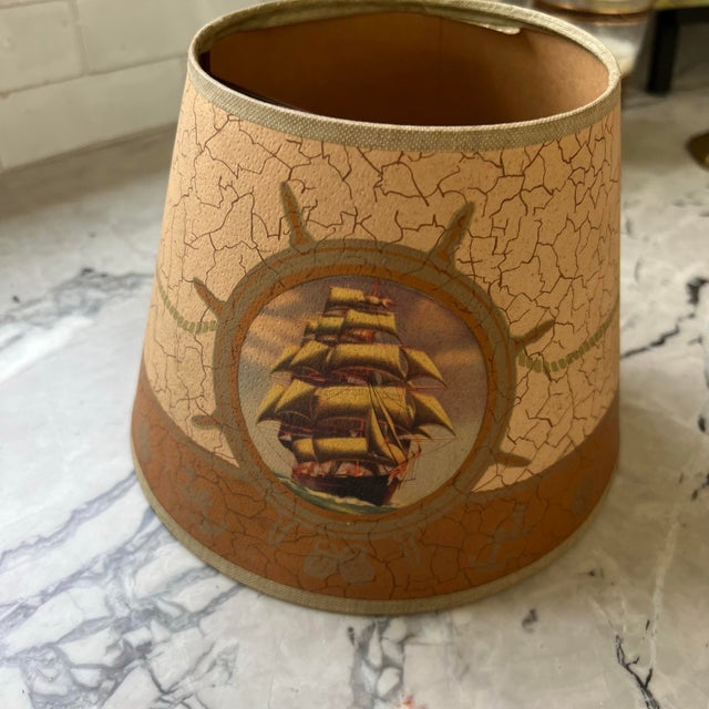 Adorable vintage lamp shade featuring a painted nautical scene with a ship and other decorative elements. It would look...