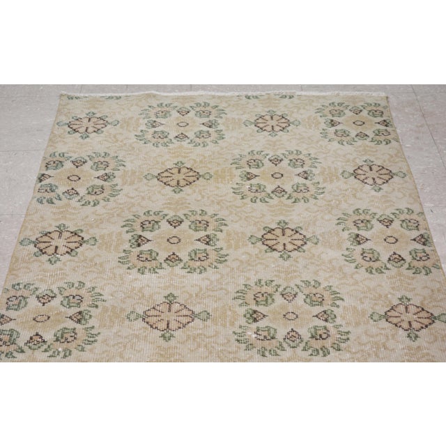 Vintage Turkish art deco handmade rug with natural colors and unique floral pattern.