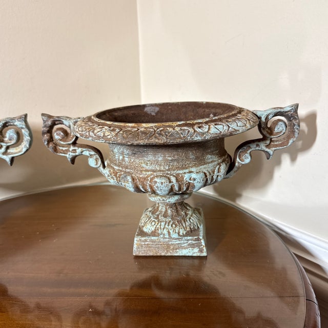 This urn has wonderful detail along its top lip, the handles and the bowl. The original blue color still lingers and...