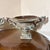 This urn has wonderful detail along its top lip, the handles and the bowl. The original blue color still lingers and...