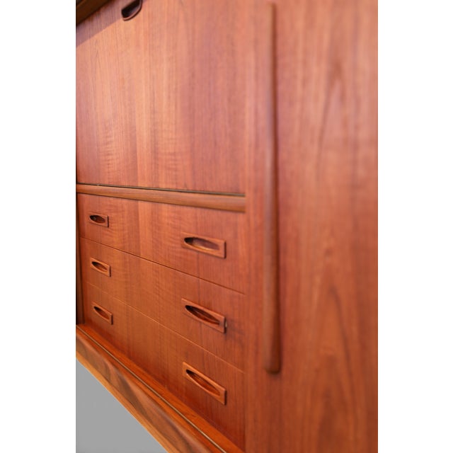 Exclusive teak cabinet from Clausen & Son with bar cabinet, sliding doors and noble wood interior - a timeless Danish...