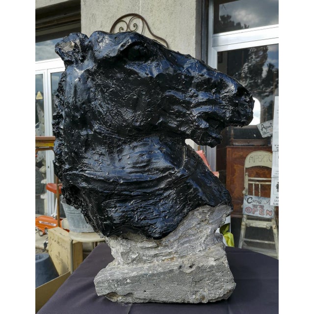 Half-bust statue depicting horse's head with a stirrup worked that decorates the neck of the horse giving an important and...