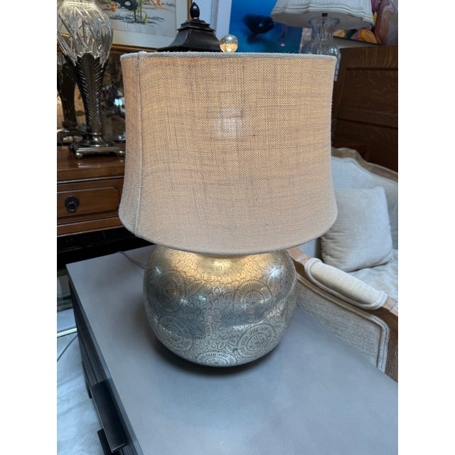 Design Plsu Gallery presents a Nickel Etched Table Lamp from Pottery Barn. The lamp has a sleek finish with ornate designs...