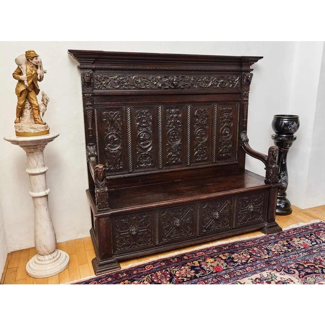 Representative neo-Renaissance bench with rich figural and plant carvings, made of solid oak wood. It dates from the end...