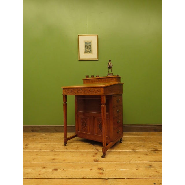 This is a handsome antique davenport desk which dates to the late 19th century. It is a distinctive looking piece which is...