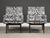A pair of mid century modern lounge chairs with walnut legs that suspend the chairs designed by Jens Risom. Newly...