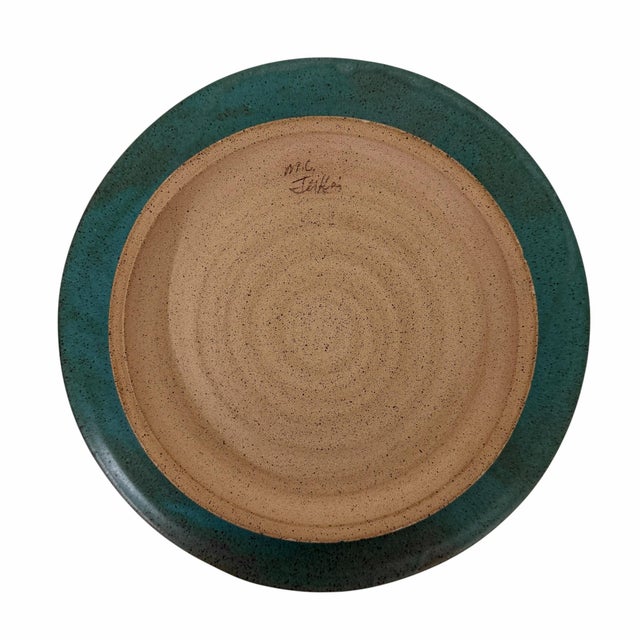 Vintage art pottery Christmas tree plate. A turquoise background shows off the hand painted tree. Measures 10.25” diameter.