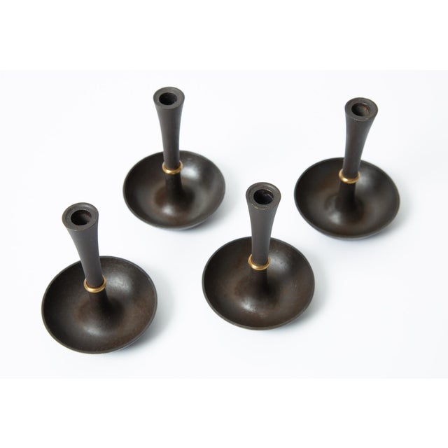 Mid-century 1960's Jens H. Quistgaard black iron candlestick holders with brass accents. set of 4, all are stamped J.H.Q...